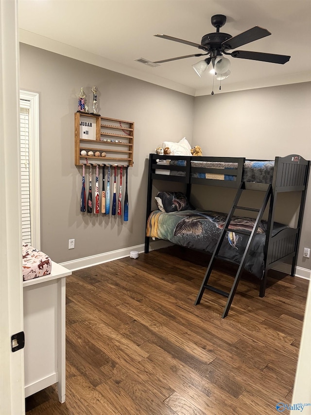 bedroom with dark hardwood / wood-style flooring and ceiling fan