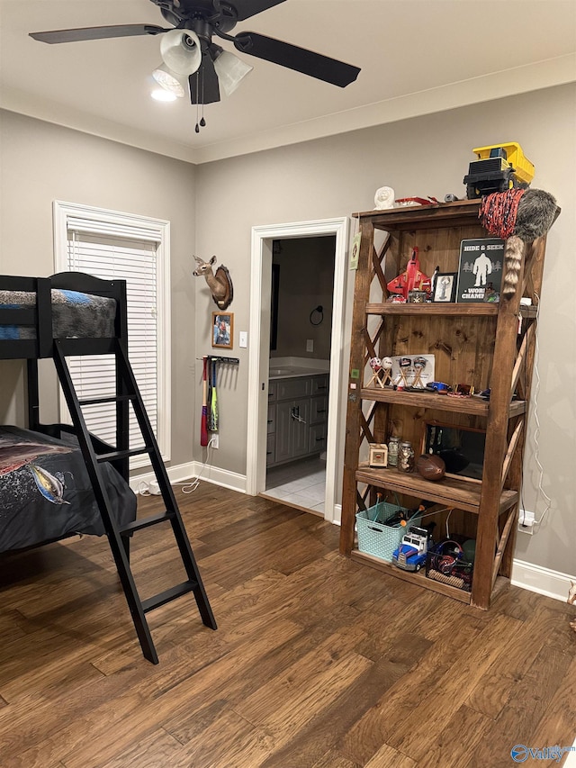 bedroom featuring crown molding, ensuite bath, and wood-type flooring