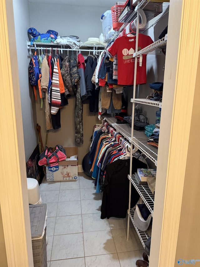 spacious closet with tile patterned floors