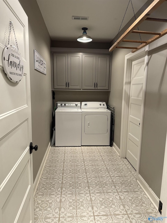 laundry room with cabinets, separate washer and dryer, and light tile patterned floors