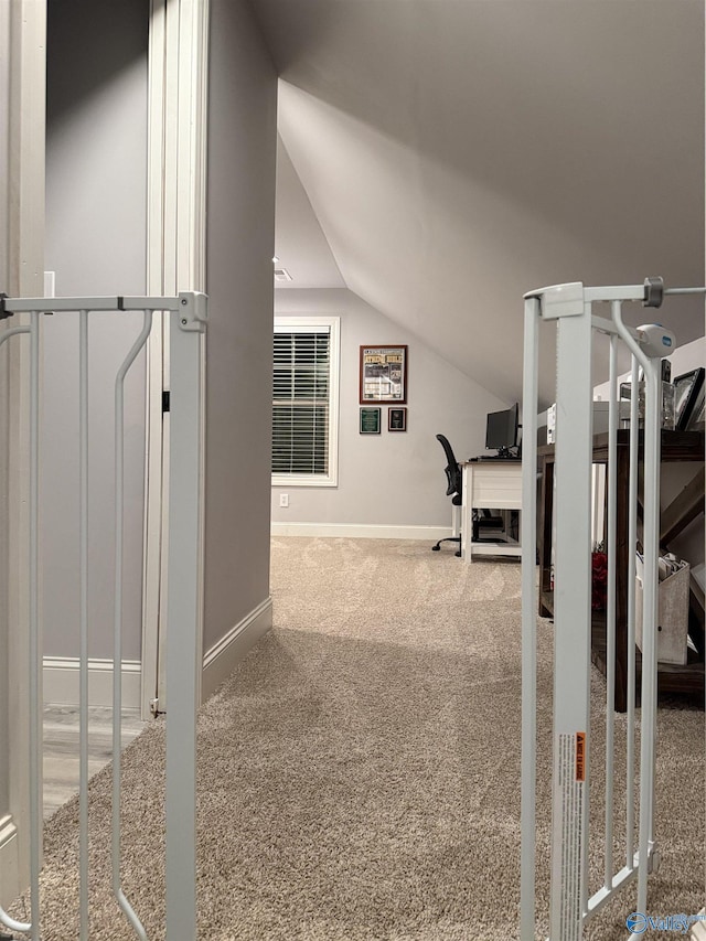 bonus room featuring vaulted ceiling and carpet