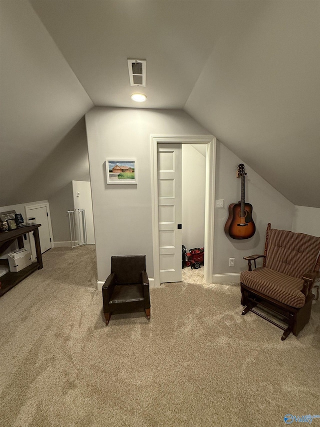 sitting room with lofted ceiling and carpet floors