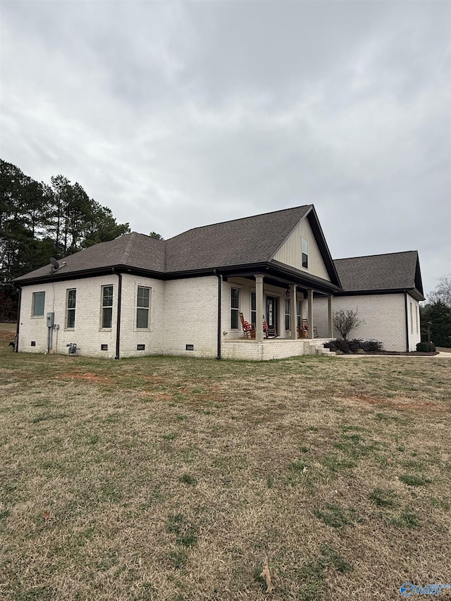 rear view of property with a yard and a patio area