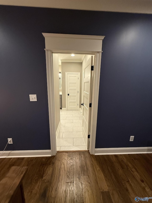 hallway with hardwood / wood-style floors