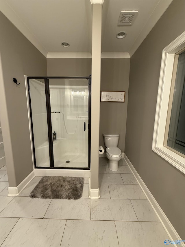 bathroom with walk in shower, crown molding, and toilet