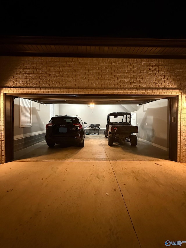 view of garage at twilight