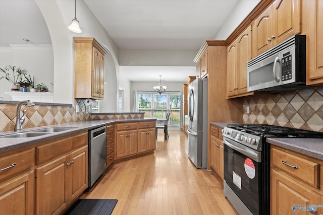 208 Honor Way, Madison, AL 35758 - kitchen featuring appliances with stainless steel finishes, a sink, a chandelier, light wood-type flooring, and dark countertops