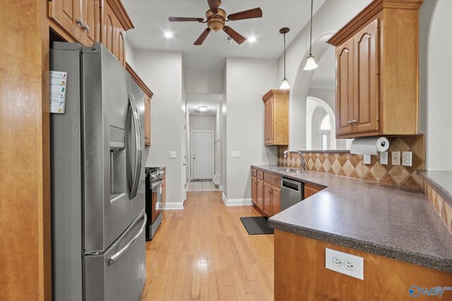 208 Honor Way, Madison, AL 35758 - kitchen featuring appliances with stainless steel finishes, a sink, ceiling fan, dark countertops, and light wood-type flooring