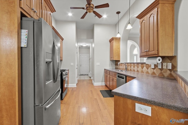 208 Honor Way, Madison, AL 35758 - kitchen featuring stainless steel appliances, a sink, a ceiling fan, dark countertops, and light wood finished floors