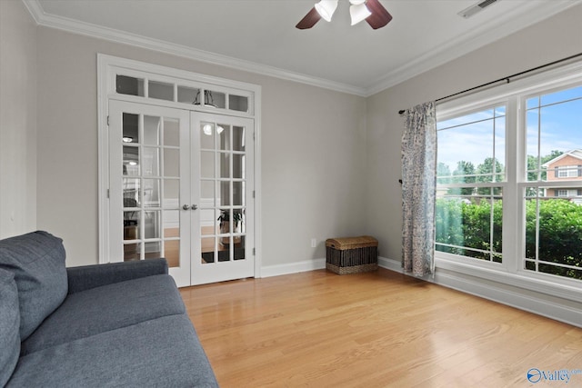 208 Honor Way, Madison, AL 35758 - living room featuring healthy amount of natural light, crown molding, light wood-type flooring, ceiling fan, and french doors