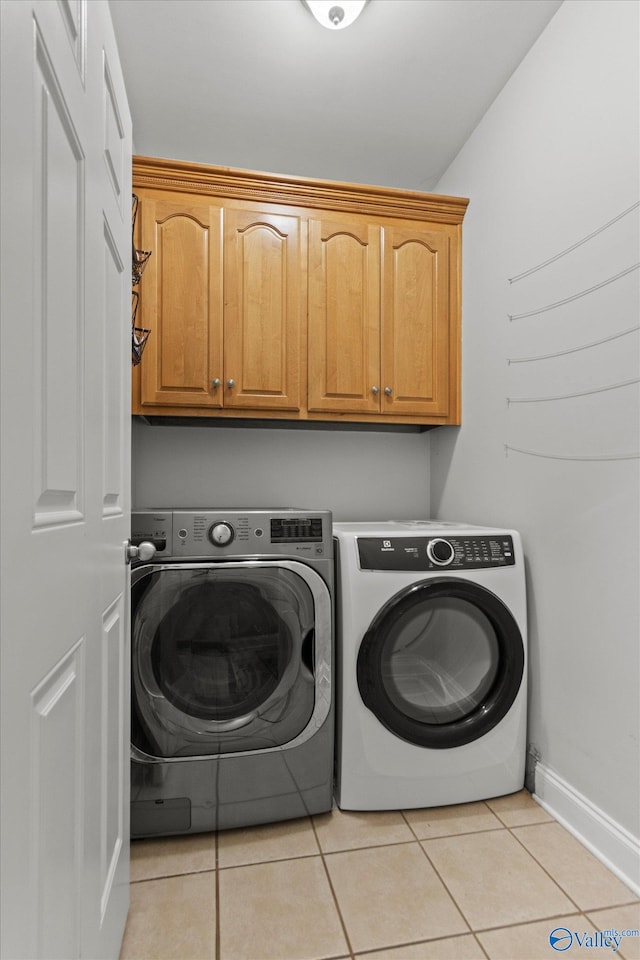 208 Honor Way, Madison, AL 35758 - laundry room with cabinet space, separate washer and dryer, light tile patterned floors, and baseboards