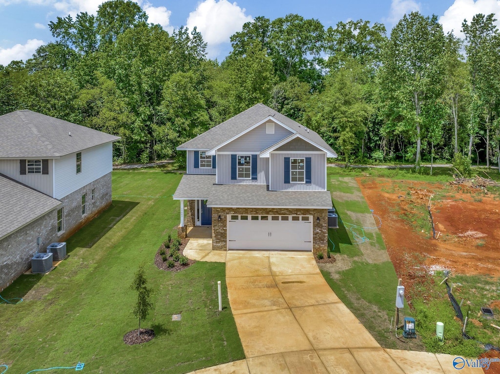 view of front of property featuring central AC unit, a garage, and a front lawn