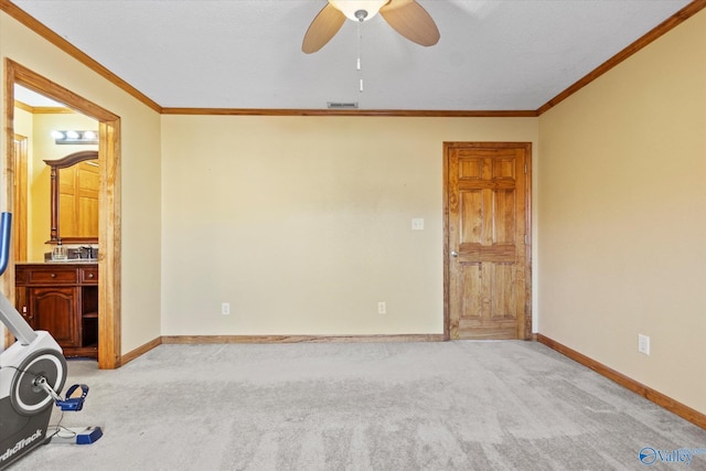 interior space with ceiling fan and ornamental molding