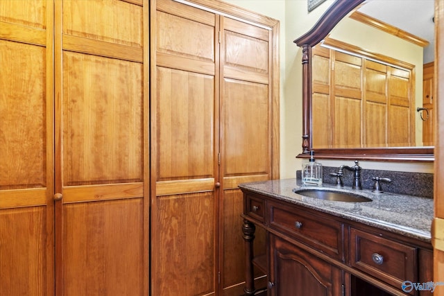 bathroom with vanity and ornamental molding