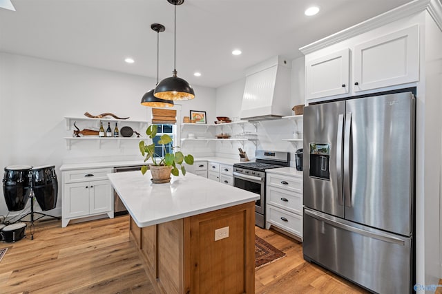 kitchen with appliances with stainless steel finishes, light countertops, open shelves, and premium range hood