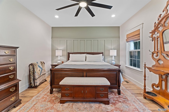bedroom featuring a decorative wall, recessed lighting, light wood finished floors, and ceiling fan