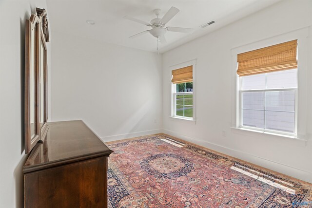 spare room featuring a ceiling fan, baseboards, and visible vents