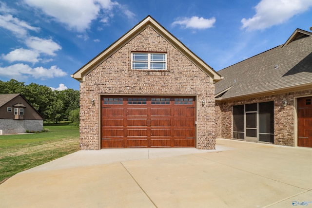 view of front of home with roof with shingles, a front lawn, brick siding, a garage, and concrete driveway