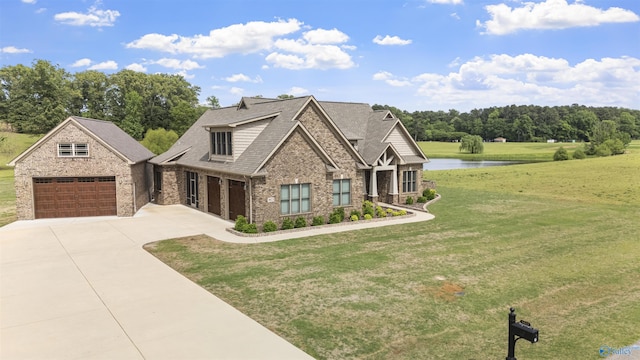 craftsman house featuring driveway, a front yard, a garage, brick siding, and a water view