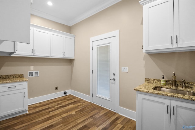 washroom with ornamental molding, hookup for a washing machine, dark wood-type flooring, a sink, and hookup for an electric dryer
