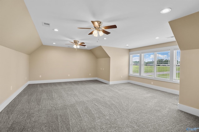 additional living space with baseboards, ceiling fan, carpet, and vaulted ceiling