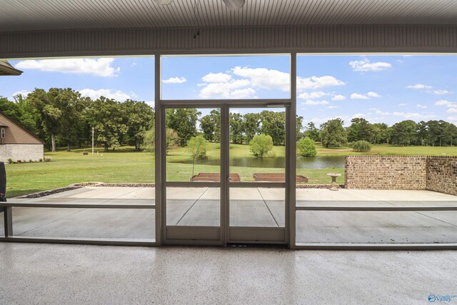 entryway featuring speckled floor, a water view, and a healthy amount of sunlight