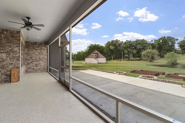 exterior space featuring ceiling fan and a fire pit
