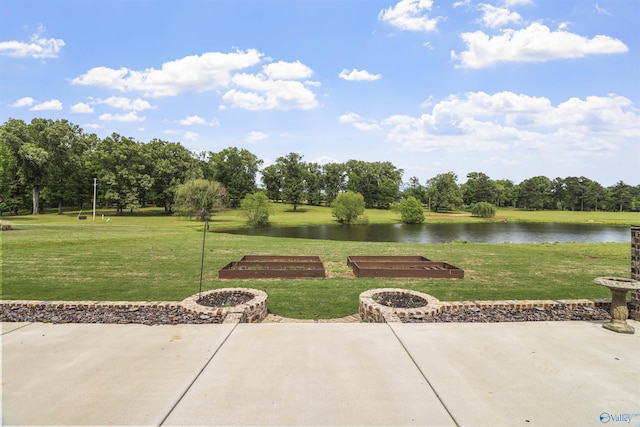 view of patio with a water view and an outdoor fire pit