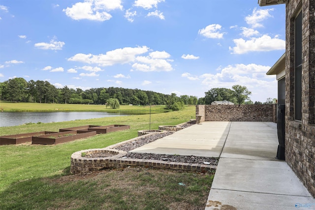 view of yard featuring a patio and a water view