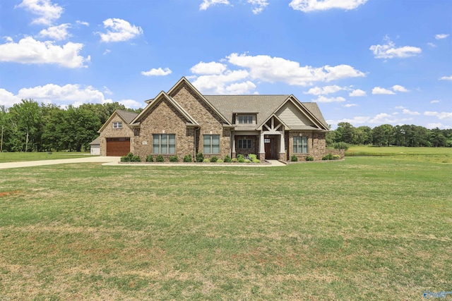 craftsman-style home featuring an attached garage, a front yard, driveway, and brick siding