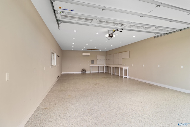 garage featuring baseboards, a garage door opener, an AC wall unit, and recessed lighting