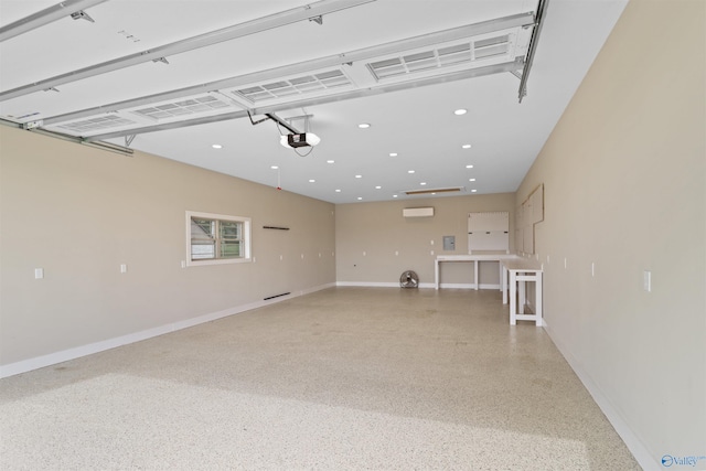 garage featuring recessed lighting, baseboards, a garage door opener, and a wall mounted air conditioner