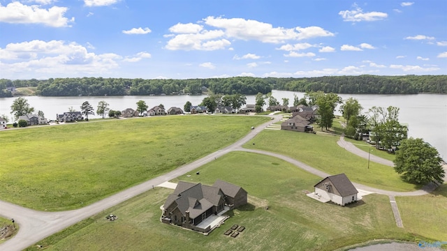drone / aerial view with a water view and a wooded view