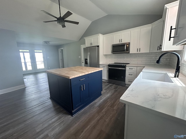 kitchen featuring appliances with stainless steel finishes, white cabinetry, and a center island