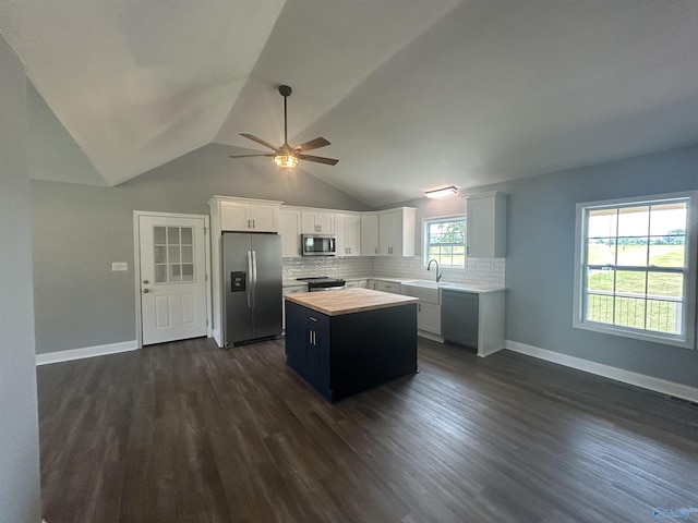 kitchen featuring a center island, light countertops, appliances with stainless steel finishes, white cabinetry, and a sink