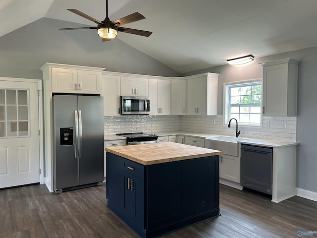 kitchen with white cabinetry, a kitchen island, appliances with stainless steel finishes, and a sink