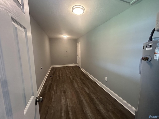 interior space featuring baseboards, dark wood-style flooring, and gas water heater