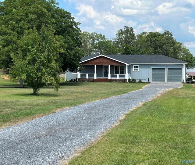 ranch-style home with a garage and a front yard