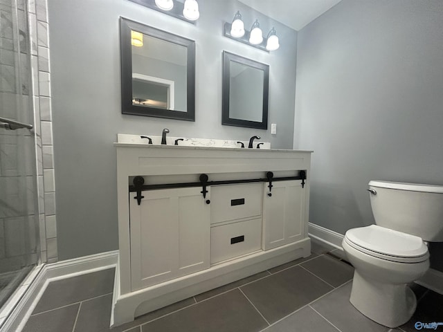 full bathroom featuring double vanity, baseboards, toilet, tile patterned floors, and a sink