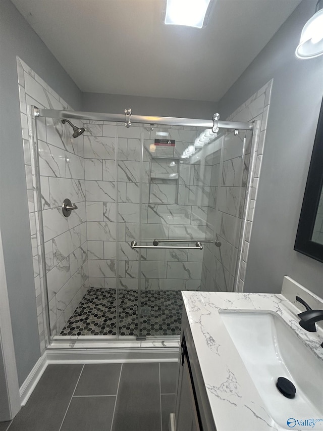 bathroom featuring a stall shower, tile patterned flooring, and vanity