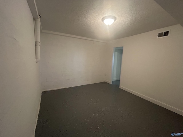 empty room with visible vents and a textured ceiling