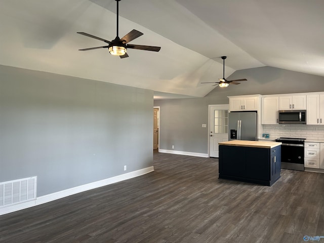 kitchen with stainless steel appliances, visible vents, white cabinets, light countertops, and a center island