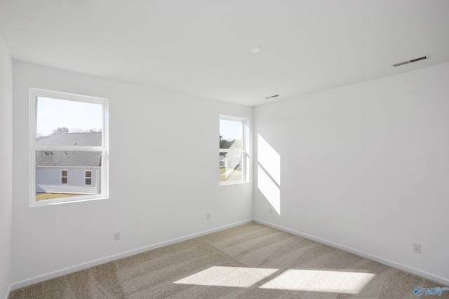 unfurnished room with light colored carpet