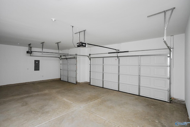 garage with a garage door opener and electric panel