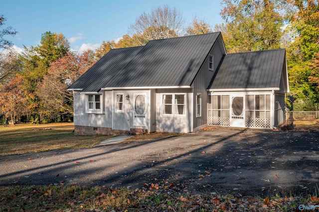 back of house with a sunroom