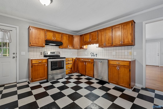 kitchen featuring backsplash, a textured ceiling, crown molding, and stainless steel appliances