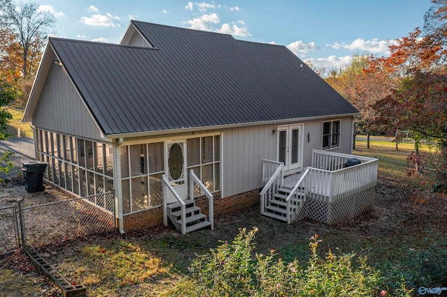 rear view of house featuring a deck