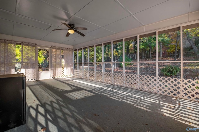 unfurnished sunroom with ceiling fan