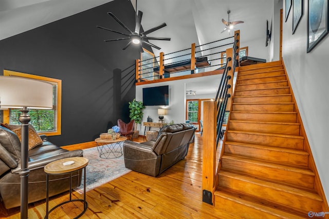 348 Rd 1951, Mentone, AL 35984 - living area featuring ceiling fan, hardwood / wood-style flooring, stairway, and high vaulted ceiling
