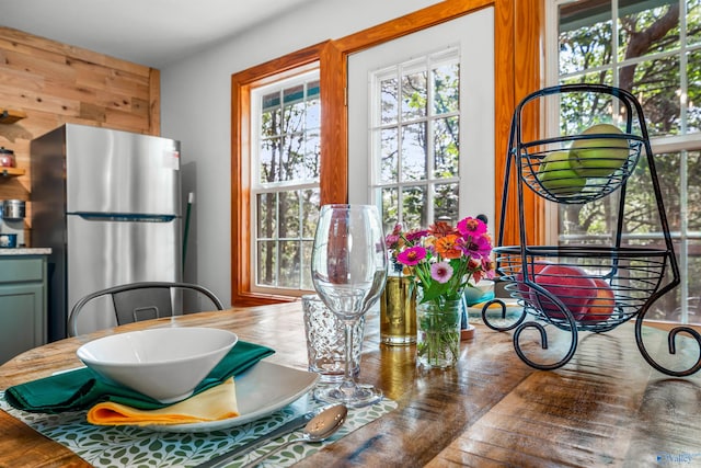 kitchen with stainless steel fridge and hardwood / wood-style flooring